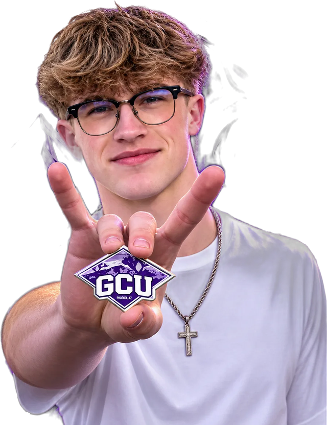 Keian, holding up a Grand Canyon University pin
